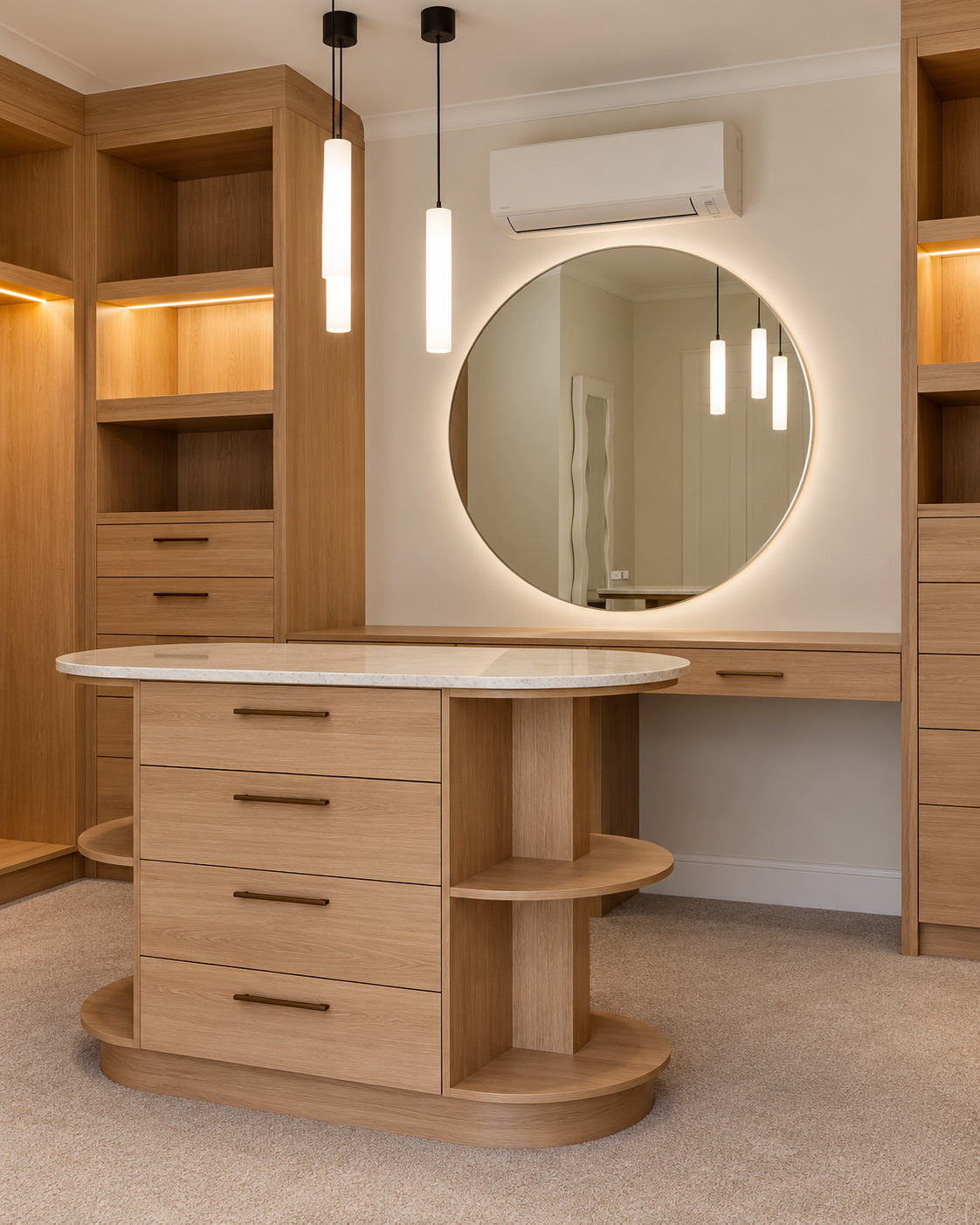 Custom timber dressing room with a curved island, circular mirror and pendant lighting