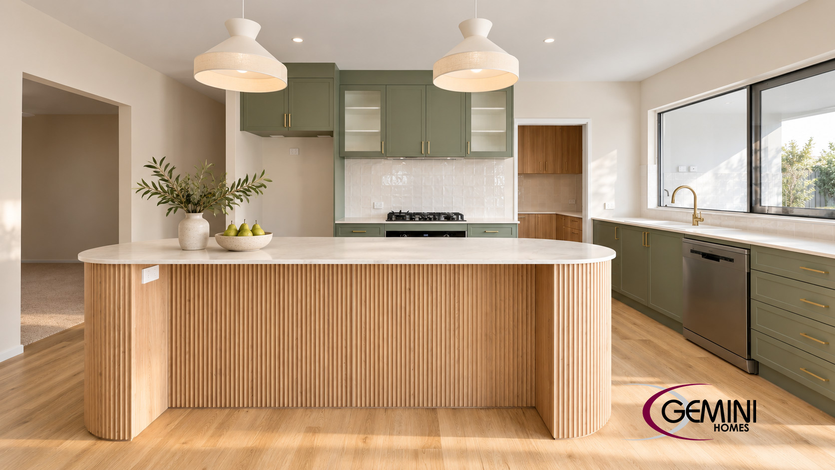 Gemini Homes kitchen with sage cabinetry, a curved timber island and pendant lighting